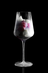 glass with raspberry and white ice and milk