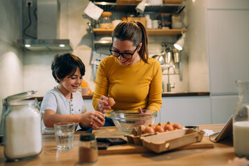 mother and her son baking together in kitchen