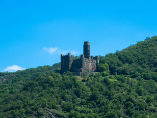 Fototapeta na wymiar Maus Castle between forests on a hill in the Middle Rhine Valley near Sankt Goarshausen in Rhineland-Palatinate, Germany