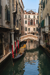 Fototapeta na wymiar Gondola in picturesque Venice canal - Venice, Italy