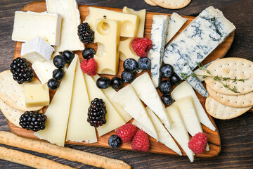 Various types of cheese on a wooden board. Сheese plate  with gorgonzola parmesan brie or...