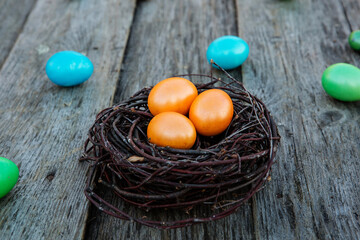 Easter eggs in the nest on wooden background