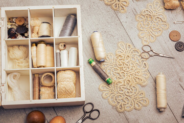 Fototapeta na wymiar Sewing supplies on a wood table