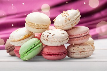 French dessert for coffee. Multicolored macarons or macaroons on desk