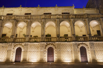 Lecce, Apulia, Italy: historic buildings in the cathedral square by night