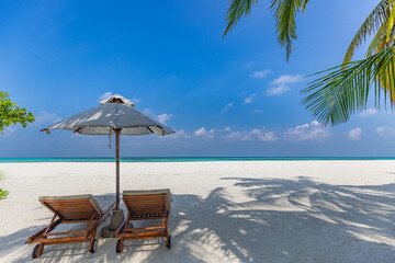 Two beach beds for couple beach travel. Summer nature landscape, tropical island shore, sea view, horizon. Exotic white sandy beach, relaxing blue sky under palm leaves. Amazing vacation landscape