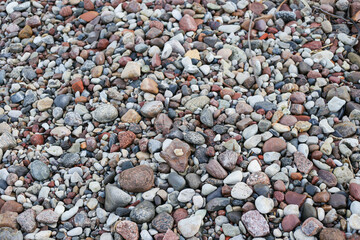Close up photography view with small and large rocks on a beach.