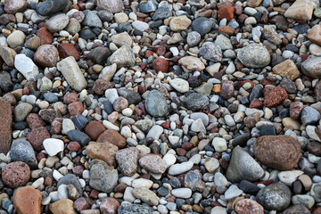 Close up photography view with small and large rocks on a beach.