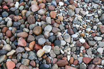 Close up photography view with small and large rocks on a beach.