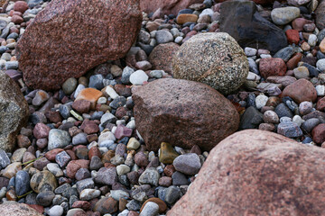 Close up photography view with small and large rocks on a beach.