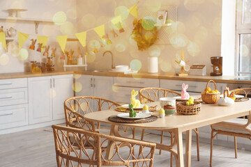 Festive table setting for Easter dinner in kitchen