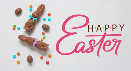 Easter greeting card with cute chocolate bunnies, eggs and candies © Pixel-Shot