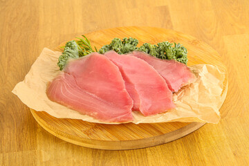 Raw salted tuna slice over board