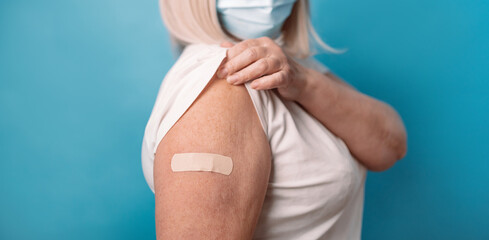 Vaccine and old elder people inoculation. Healthy mature older senior 50s woman in protective...