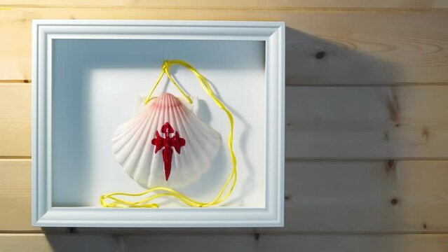 decorative wooden frame with pilgrim shell scallop from the Camino de Santiago to Compostela Galicia Spain , hd video footage