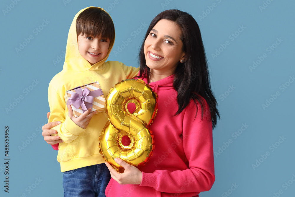 Poster Little son and his mother with gift and balloon in shape of figure 8 on color background. International Women's Day celebration