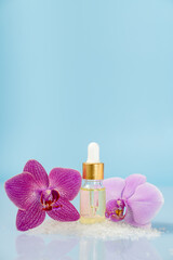 beauty oil with orchid flowers, spa, space for text, self care concept