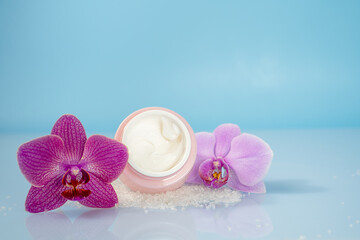 Fototapeta na wymiar body cream and orchid flowers, body care concept, spa, background