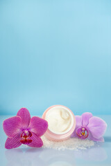 Obraz na płótnie Canvas body cream and orchid flowers, body care concept, spa, background