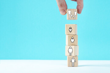 Hand puts a dice with family symbol