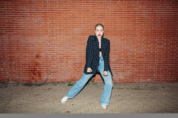 Fototapeta na wymiar Young bald woman dancing in the street.