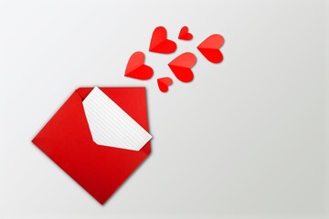 Red paper envelope with empty white card and heart, valentines day concept.