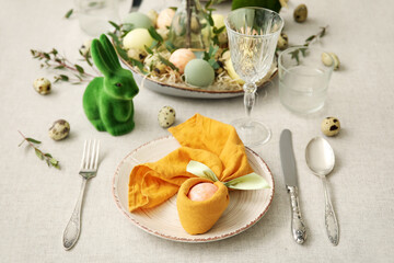 Festive table setting for Easter celebration on light background