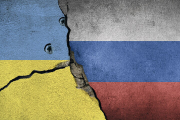 Ukraine and russia flag painted on concrete wall with bullet holes. To simulate the conflict...