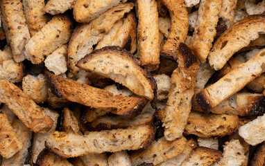 Rye bread fried croutons with garlic as background.