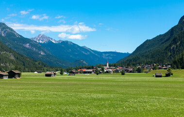 Fototapeta na wymiar Panoramic view of a idyllic landscape with a mountains and blue sky in the Bavarian Alps against blue sky. Tannheimer Tal, Reutte, Austria
