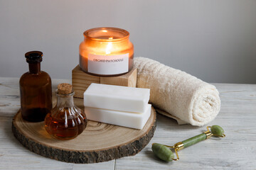 beauty treatment items for spa procedures on white wooden table, soap, candle, , essential oils....