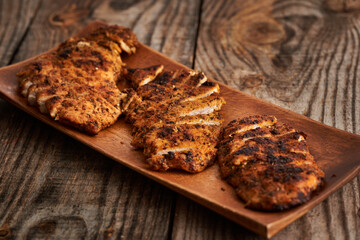 Fried chicken breast on a wooden board