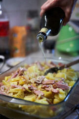Ham and potatoes with parmesan and herbs in a tray