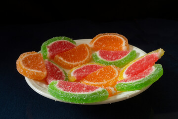 Slices of sweet marmalade on the table close-up