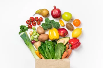 Fototapeten Healthy food background. Healthy food in paper bag vegetables and fruits on white. Food delivery, shopping food supermarket concept © missmimimina