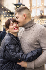 young beautiful couple walking and having fun on the city street