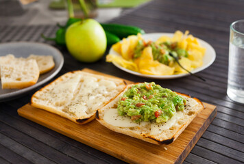 healthy breakfast. toasted italian ciabatta bread with melted cheese and avocado puree