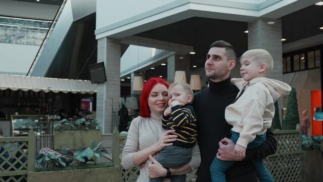 family holding children in their arms at the mall