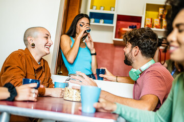 Group of young people having breakfast at coffee bar of an hostel, friends talking and having fun together at living room, diverse gen z people at brunch on vacation - obrazy, fototapety, plakaty