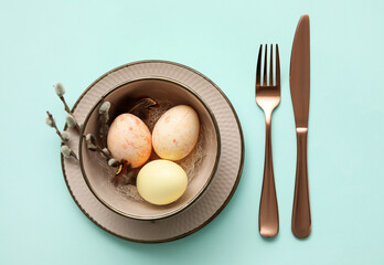 Stylish table setting for Easter celebration on turquoise background