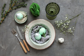 Stylish table setting for Easter celebration with gypsophila flowers on grey background