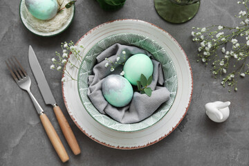 Fototapeta na wymiar Stylish table setting for Easter celebration with gypsophila flowers on grey background