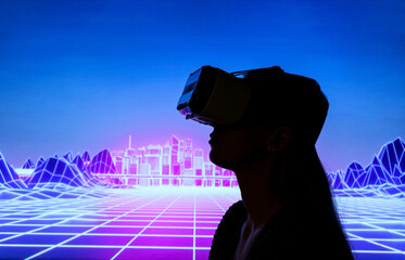 the silhouette of Female person using Virtual reality headset in metaverse universe. Experiencing...