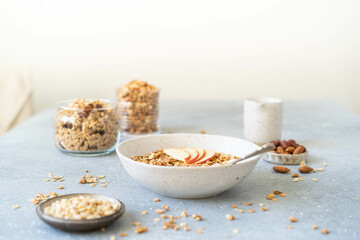 Homemade granola with milk, apples and nuts. Delicious and healthy breakfast.