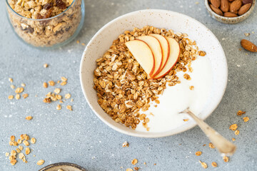 Homemade granola with milk, apples and nuts. Delicious and healthy breakfast.