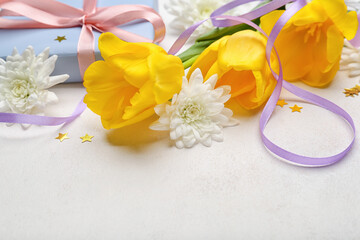 Composition with beautiful flowers for International Women's Day celebration on light background, closeup
