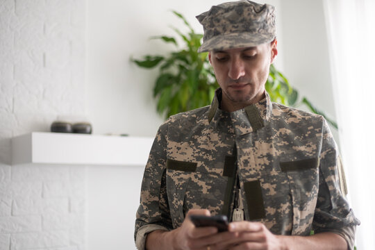 Military Soldier Using Mobile Phone. Letter