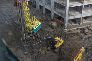 The construction process of a residential complex. Many high-rise cranes against the background of new buildings