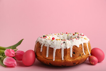 Tasty Easter cake with eggs and flowers on pink background
