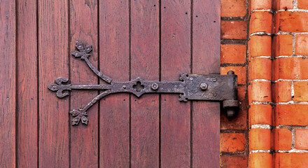 General view and close-up of architectural details of the Catholic church of Saint Bruno built in the neo-Gothic style in the city of Bartoszyce in warmi in Poland, built in the years 1882-83.